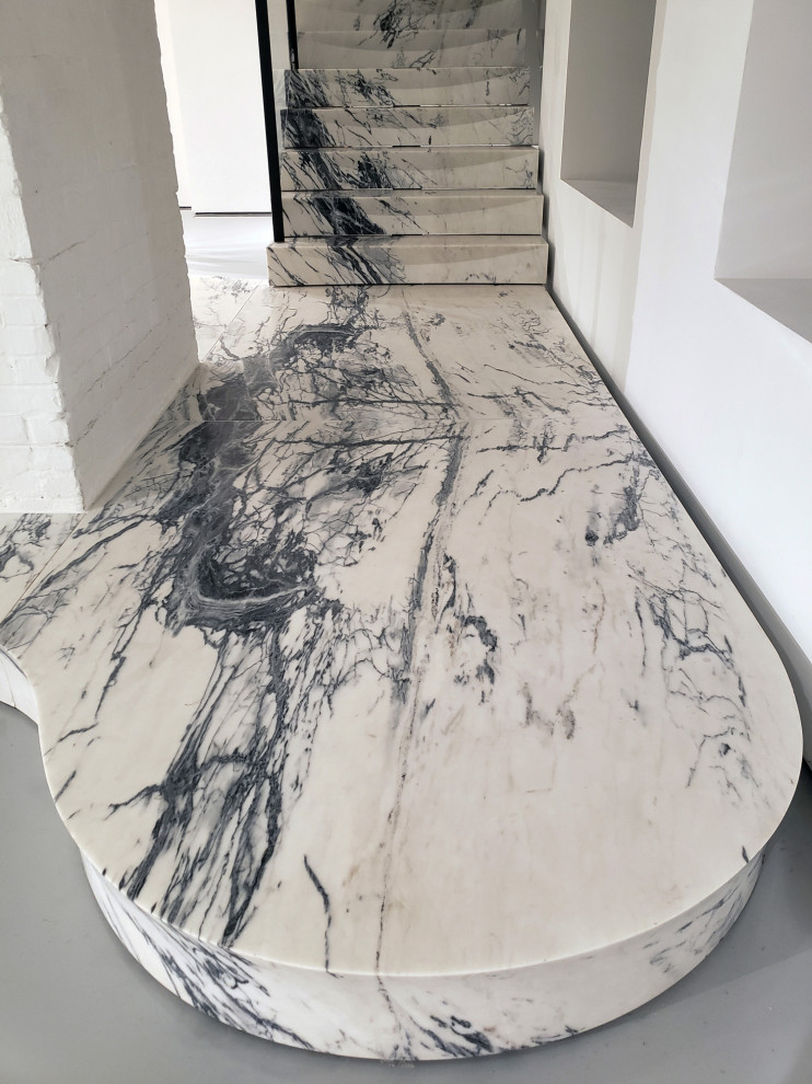Staircase - huge modern marble floating staircase idea in New York with marble risers