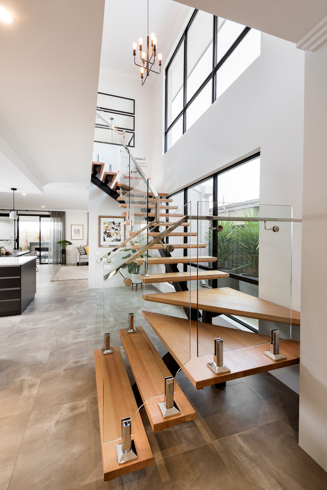 Foto de escalera en U minimalista grande sin contrahuella con escalones de madera