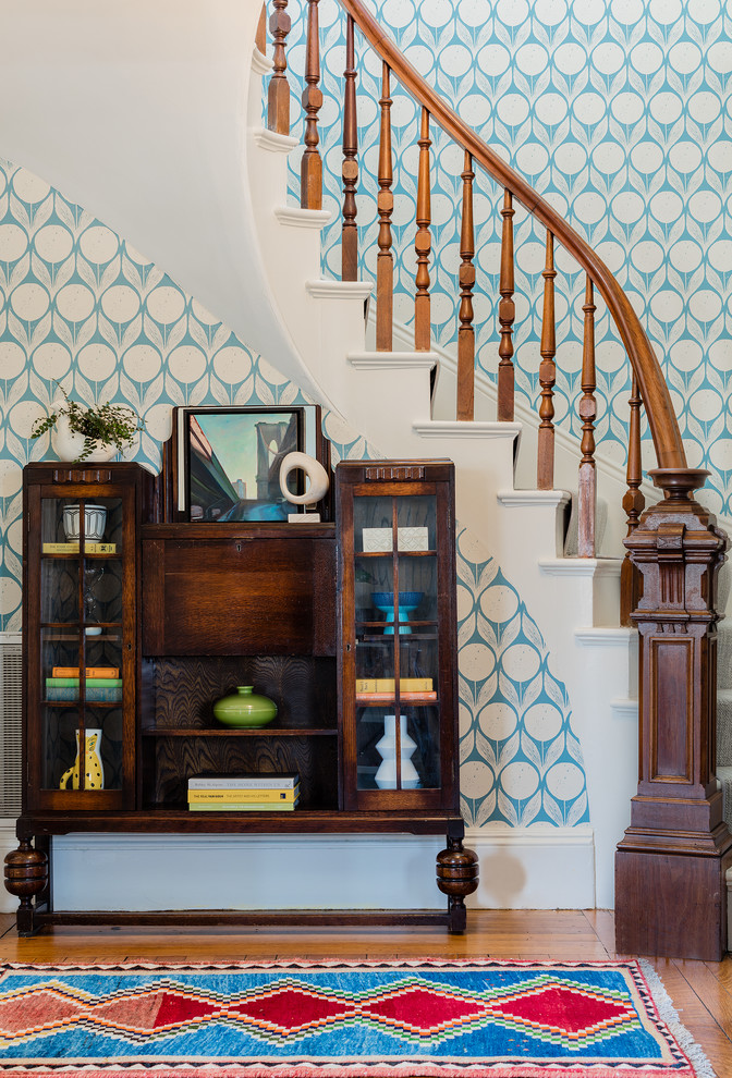 Staircase - transitional carpeted curved wood railing staircase idea in Boston with carpeted risers