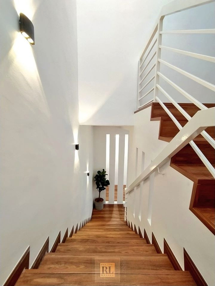 他の地域にある低価格の中くらいな北欧スタイルのおしゃれな折り返し階段 (木の蹴込み板、金属の手すり) の写真