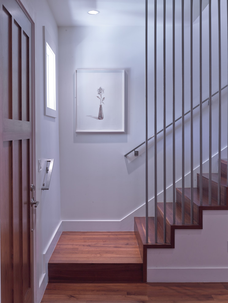 Inspiration for a mid-sized modern wooden straight staircase remodel in San Francisco with wooden risers