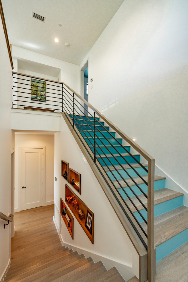 Inspiration for a large traditional wood metal railing staircase in Austin with wood risers.