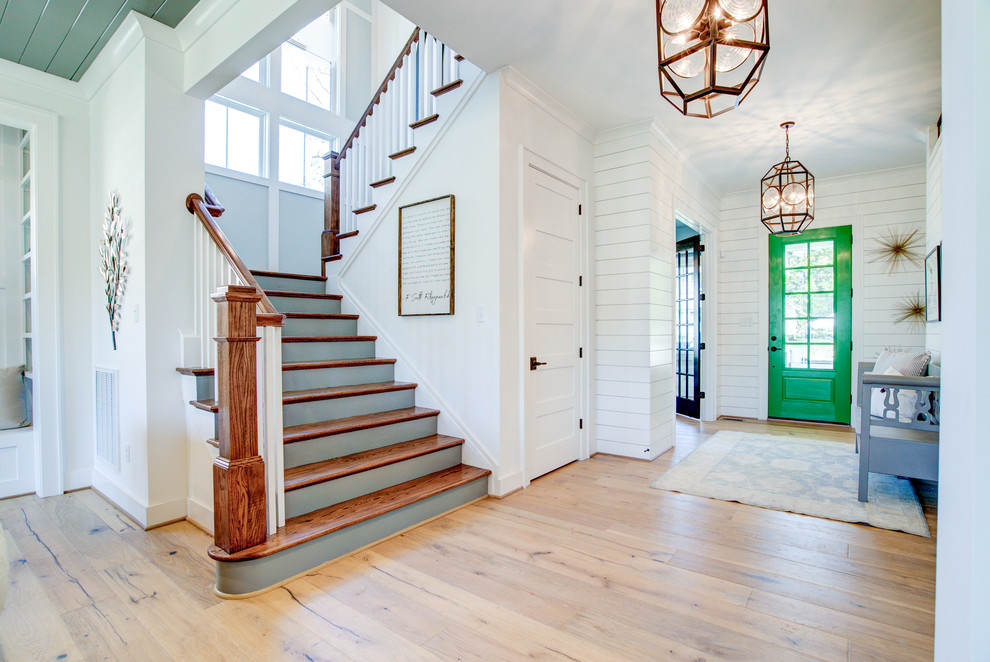 Imagen de escalera en U de estilo de casa de campo grande con escalones de madera, contrahuellas de madera pintada y barandilla de madera