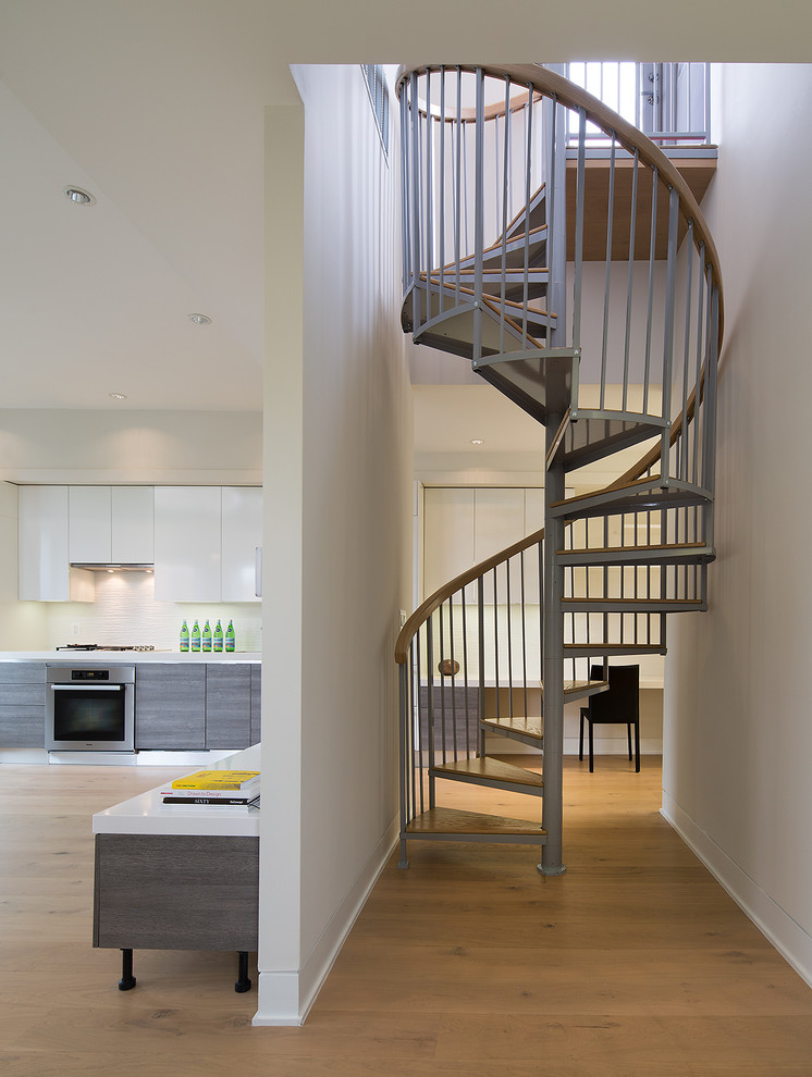Photo of a contemporary wood spiral staircase in DC Metro with open risers.