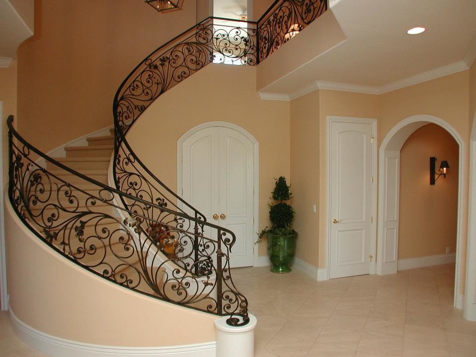 Inspiration for an expansive traditional carpeted curved metal railing staircase in Sacramento with carpeted risers.
