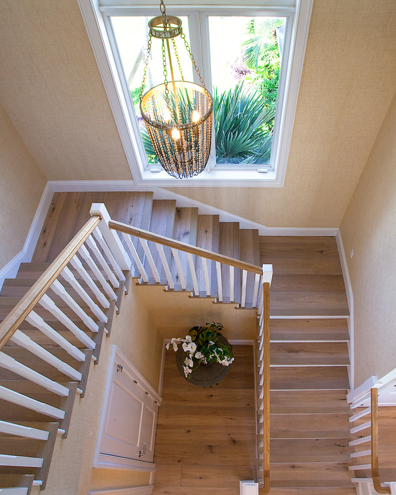 Inspiration for a large nautical wood u-shaped wood railing staircase in Miami with wood risers.
