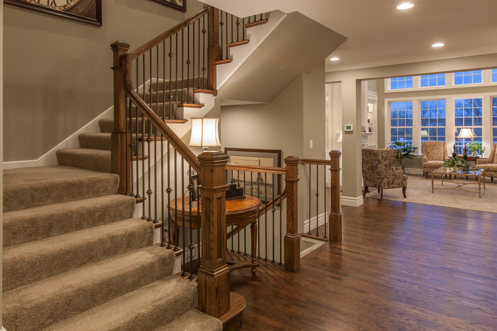 Large trendy carpeted l-shaped staircase photo in St Louis with carpeted risers
