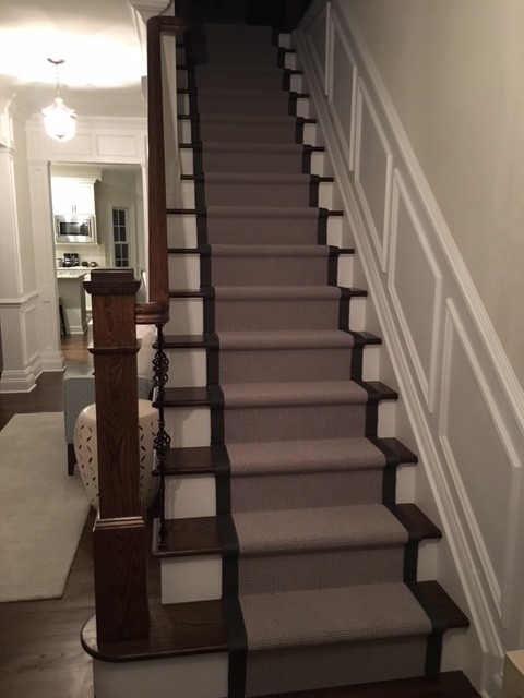 Photo of a medium sized traditional staircase in New York.