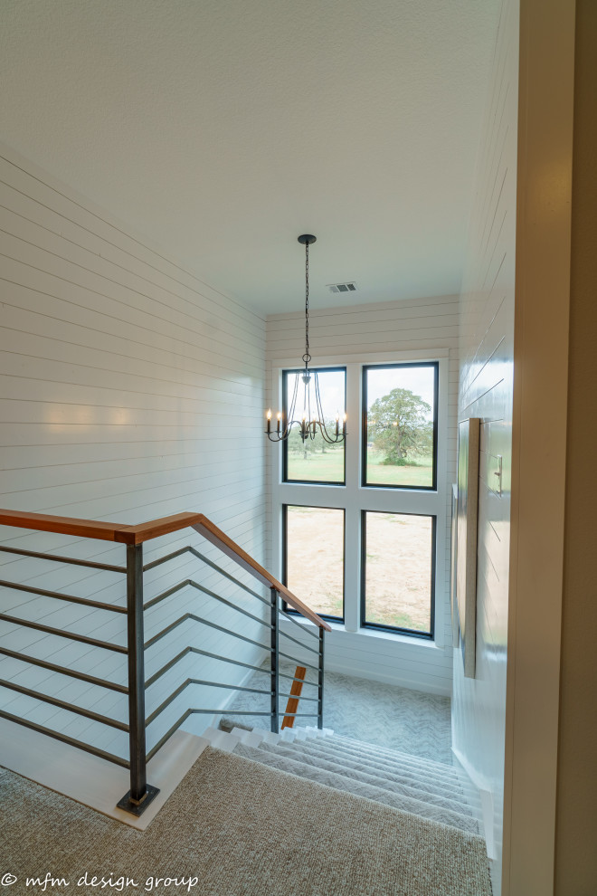 Example of a mid-sized cottage carpeted u-shaped metal railing and shiplap wall staircase design in Austin with carpeted risers