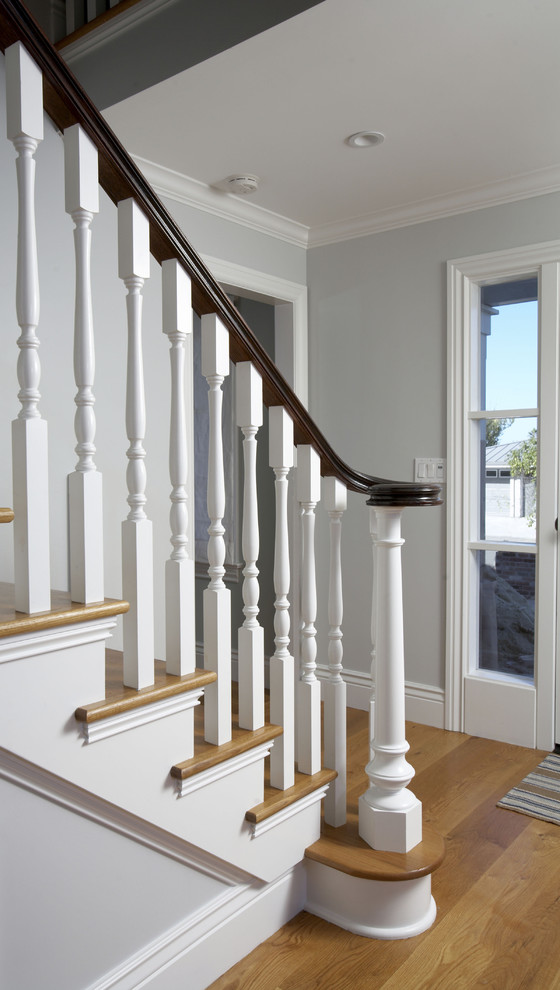 Inspiration for a mid-sized timeless wooden straight staircase remodel in San Francisco with painted risers