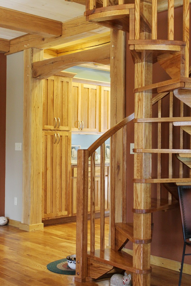 Small rustic wood spiral staircase in Nashville with open risers.