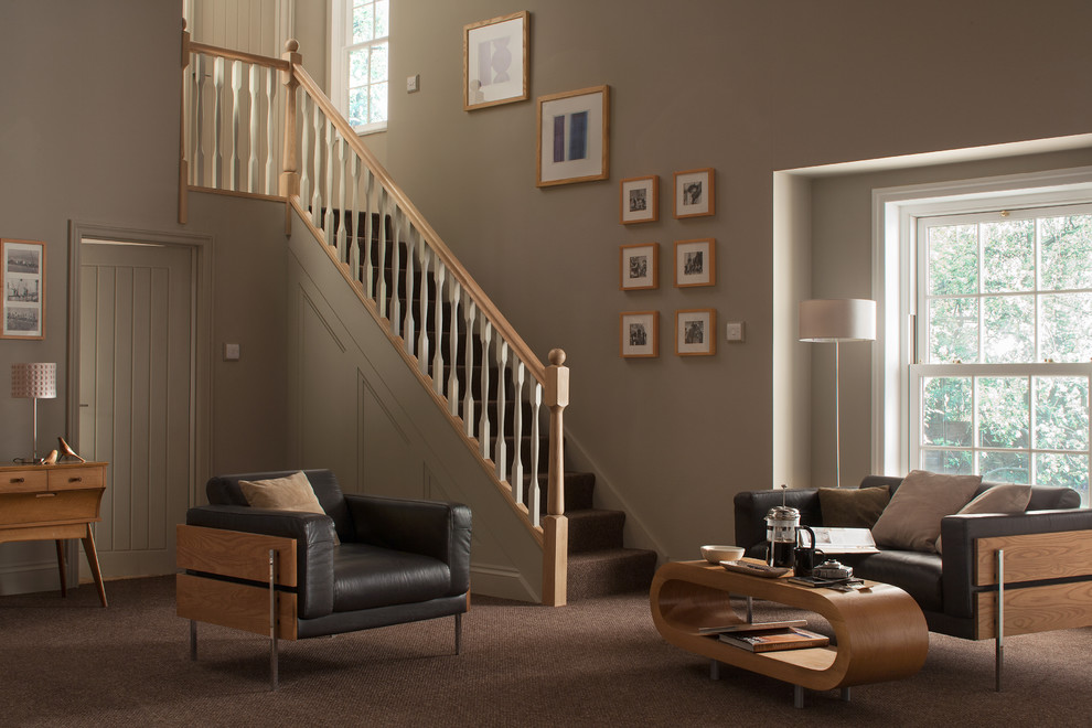Photo of a modern carpeted straight wood railing staircase with carpeted risers and feature lighting.