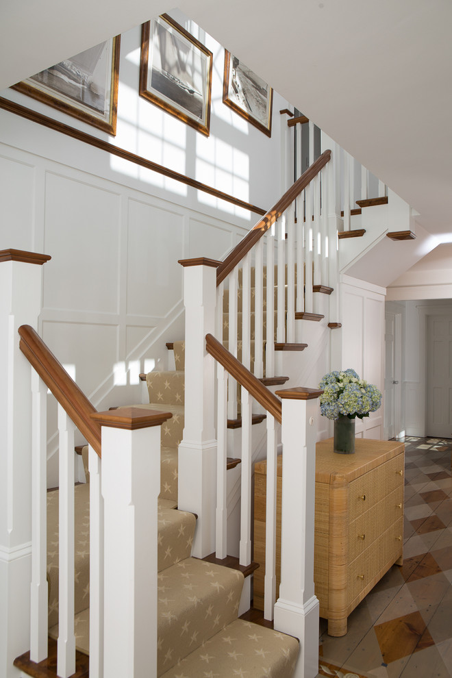 This is an example of a large beach style carpeted u-shaped staircase in Boston with carpeted risers.