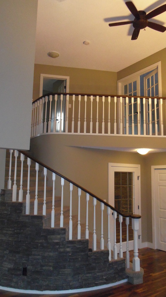 Staircase - large transitional carpeted curved staircase idea in Calgary with carpeted risers
