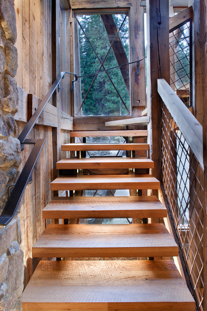 Design ideas for a rustic wood floating staircase in Denver with open risers and feature lighting.