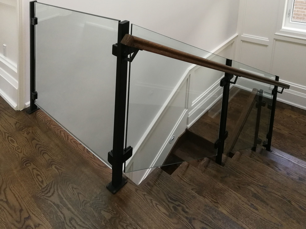 Elegant wooden straight glass railing staircase photo in Toronto with wooden risers