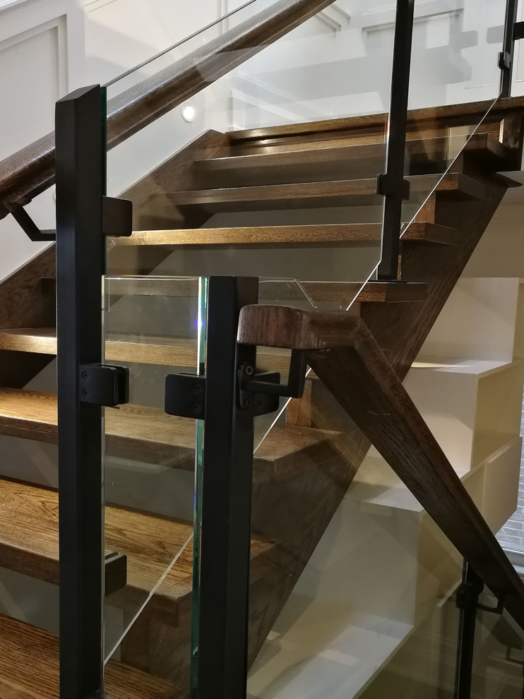 トロントにある高級なトラディショナルスタイルのおしゃれな直階段 (木の蹴込み板、ガラスフェンス) の写真