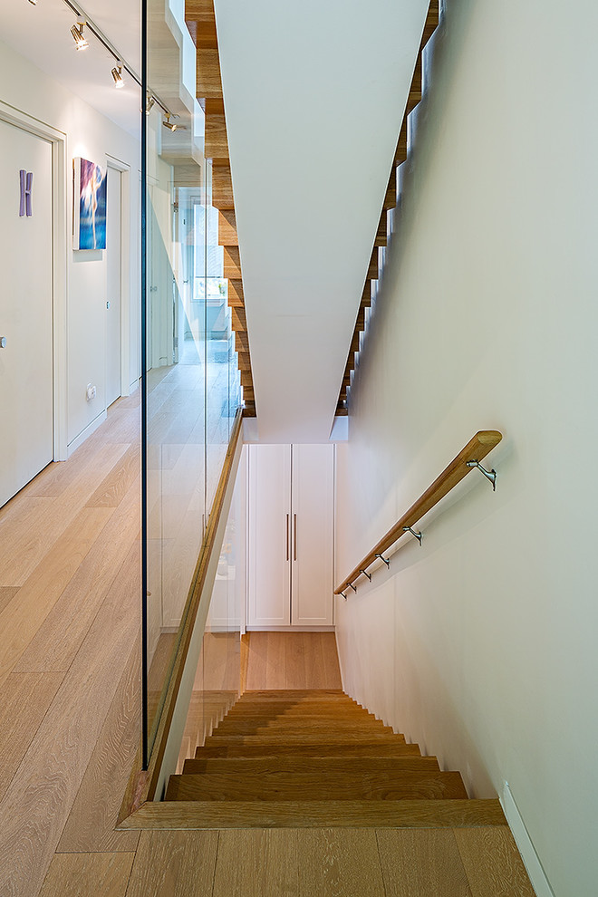 Design ideas for a contemporary staircase in Toronto with feature lighting.