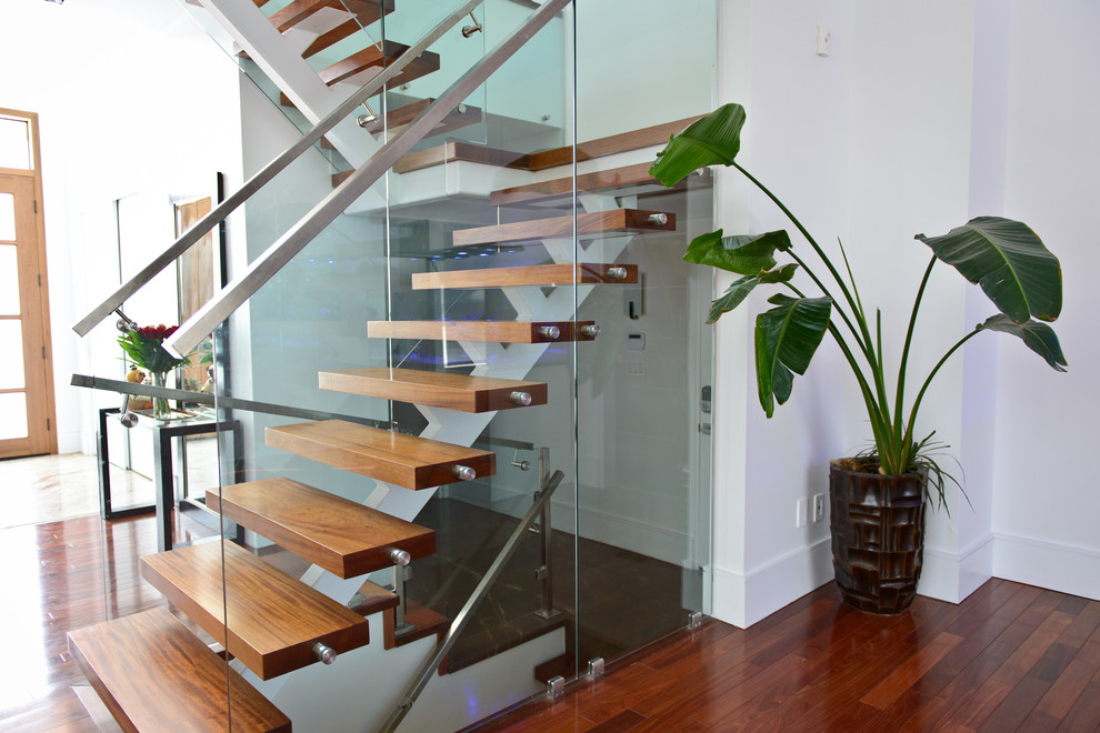 Design ideas for a medium sized contemporary wood u-shaped glass railing staircase in Toronto with open risers.