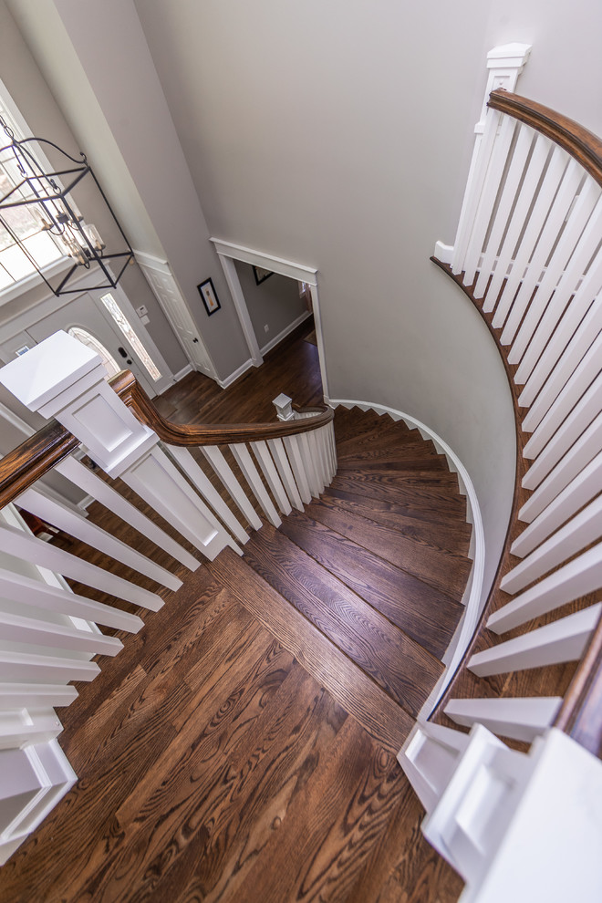 Inspiration for a large traditional wood curved wood railing staircase in Baltimore with painted wood risers.