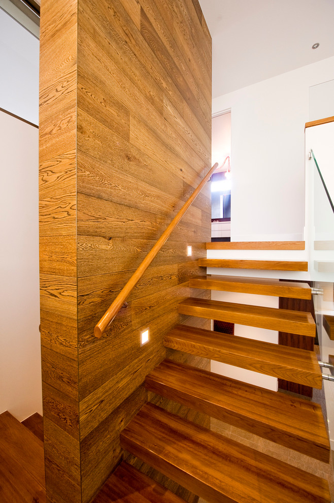 Medium sized contemporary wood floating staircase in Melbourne with open risers.