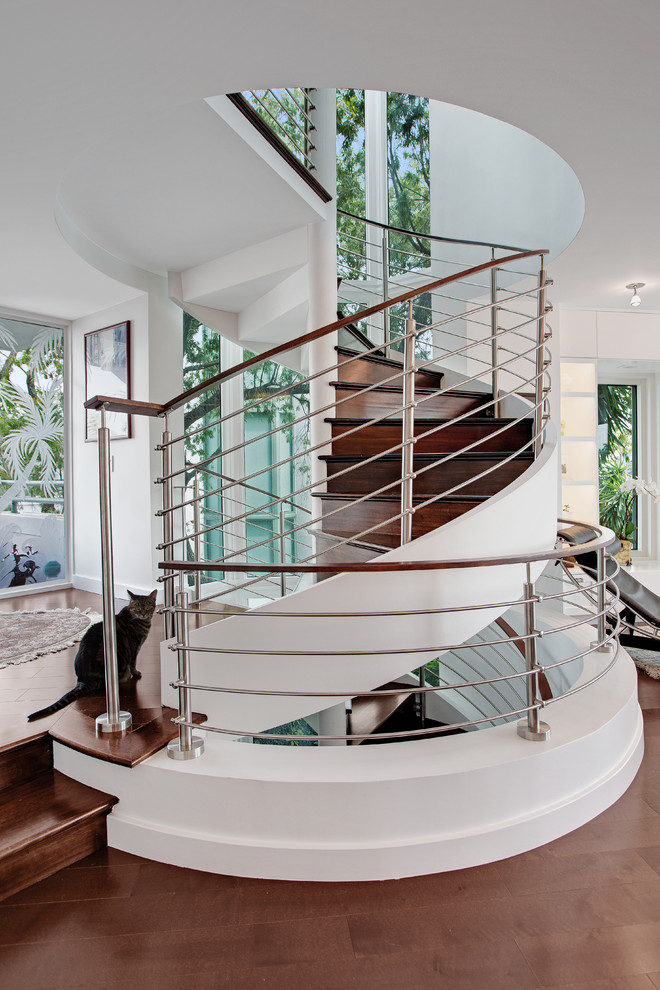 Inspiration for a contemporary wood spiral staircase in Tampa with wood risers.