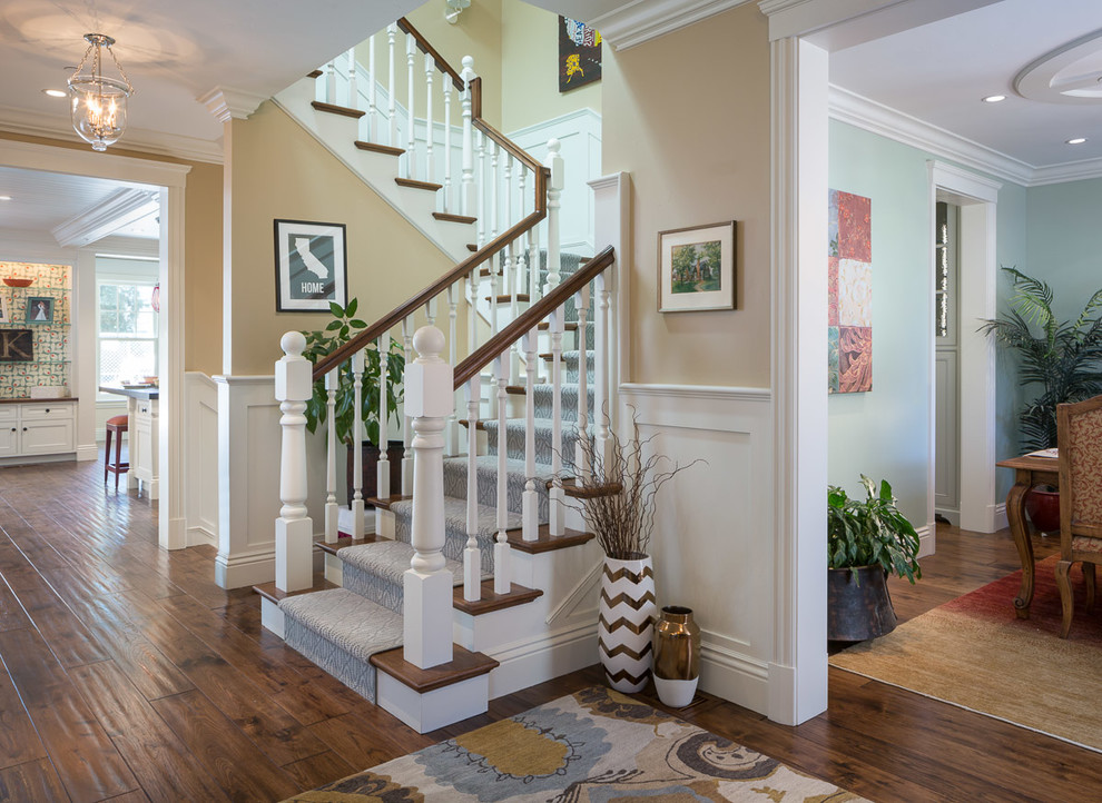 Inspiration for a classic wood u-shaped staircase in San Francisco with painted wood risers.