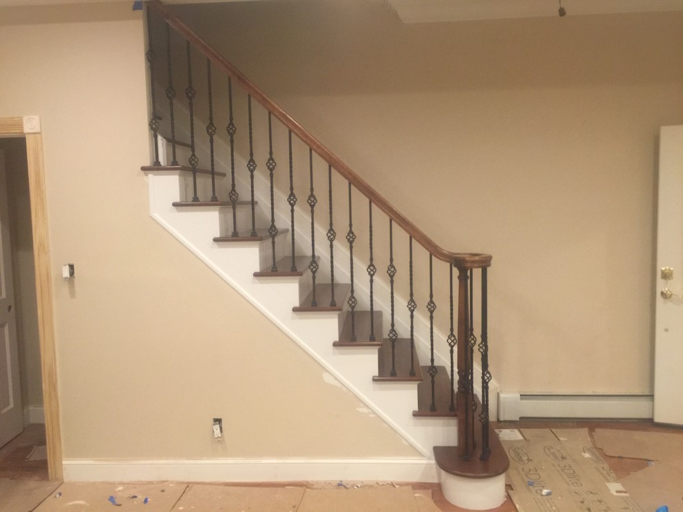 Photo of a medium sized classic wood straight staircase in New York with painted wood risers.