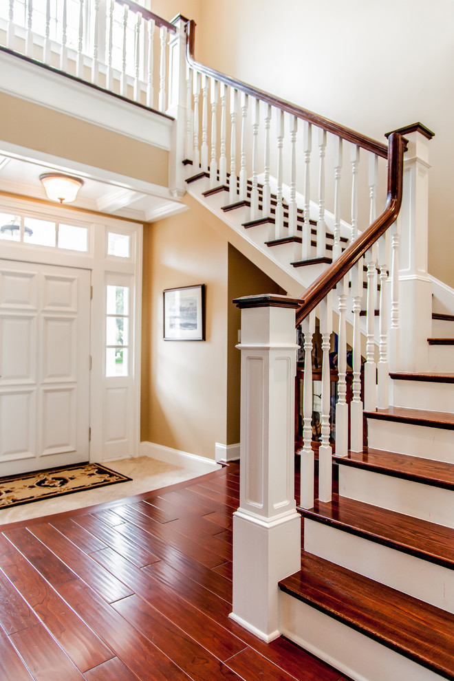 Mid-sized trendy wooden u-shaped staircase photo in Jacksonville with painted risers
