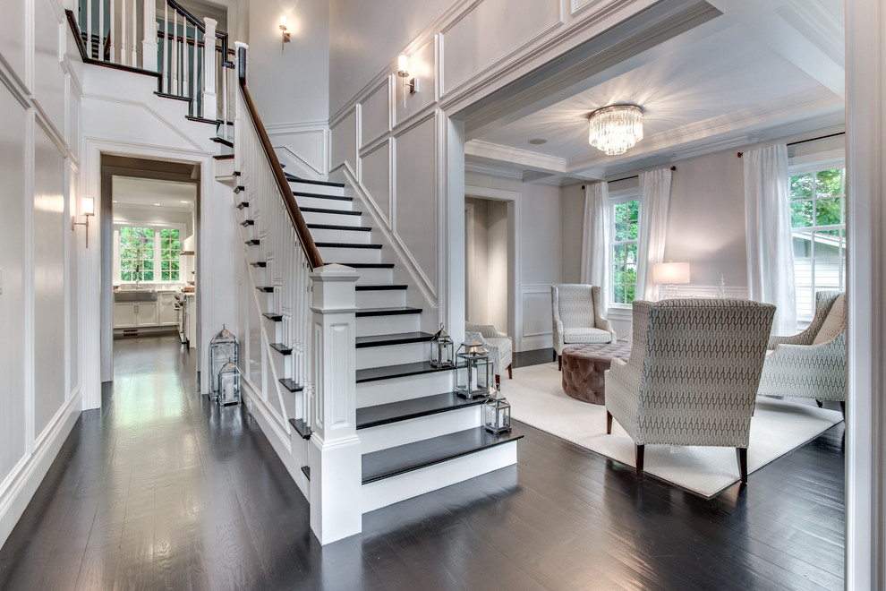 Classic wood staircase in Boston with painted wood risers and feature lighting.