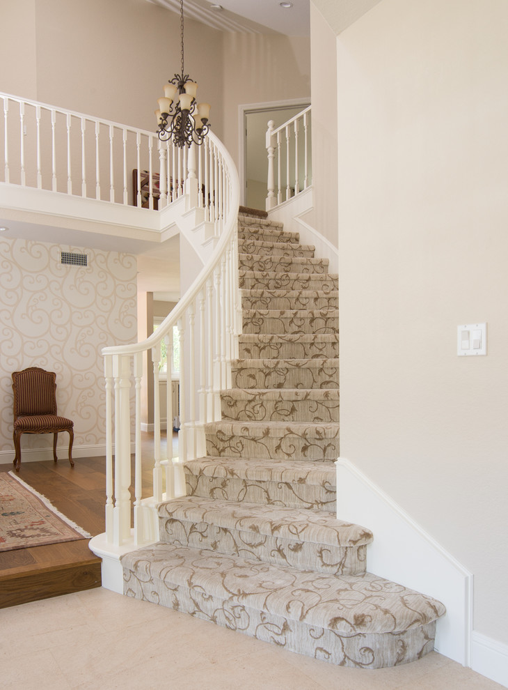 Inspiration for a mid-sized transitional carpeted curved staircase remodel in Los Angeles with carpeted risers