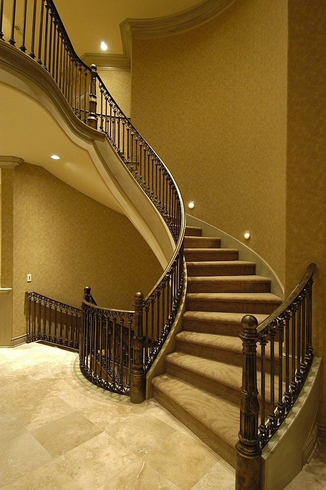 Inspiration for an expansive classic carpeted curved staircase in Omaha with carpeted risers.