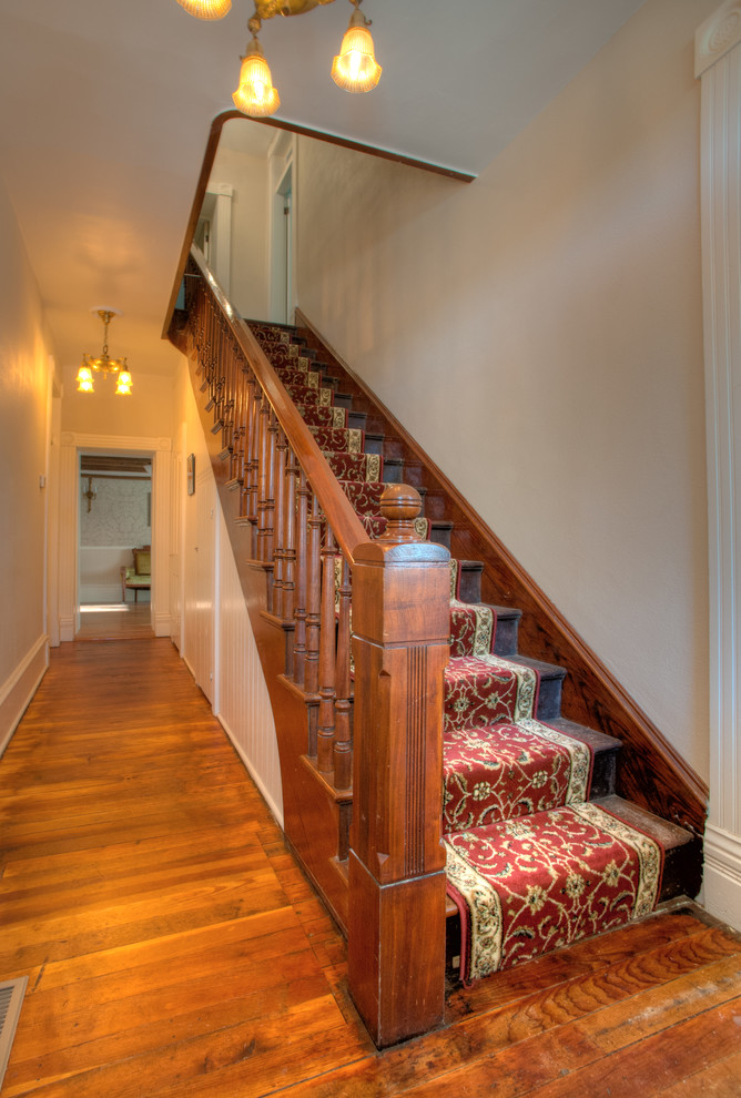 Inspiration for a mid-sized transitional wooden straight wood railing staircase remodel in Other with wooden risers