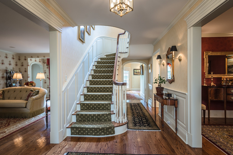 Example of a large classic carpeted u-shaped staircase design with wooden risers