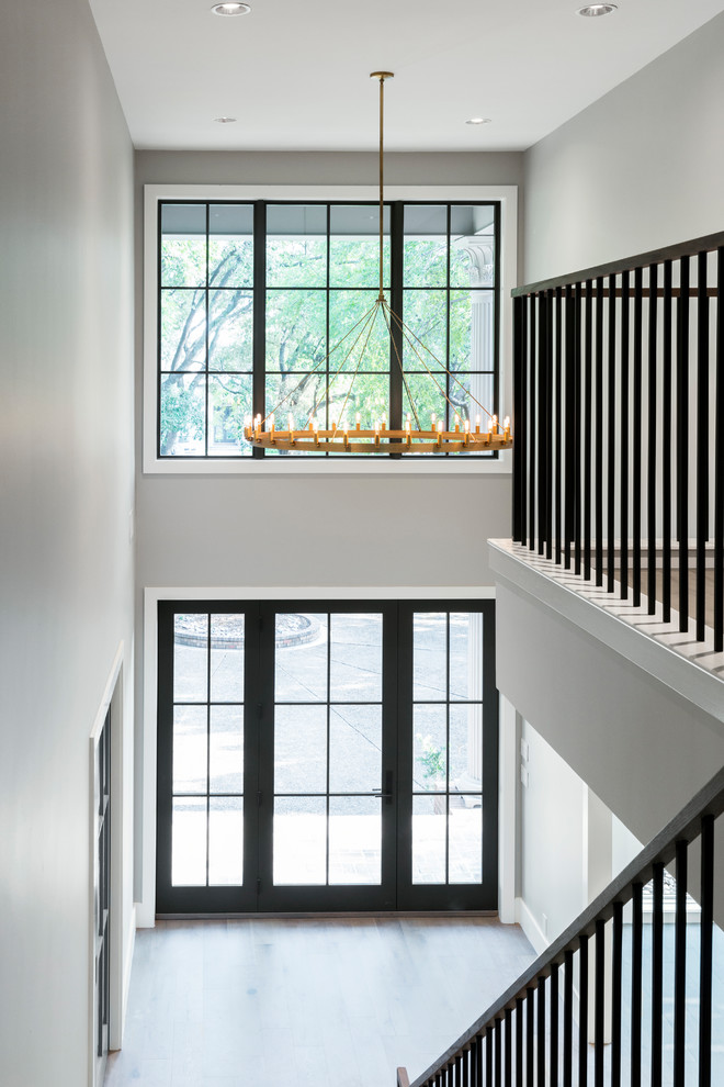 This is an example of a small traditional wood l-shaped metal railing staircase with wood risers.