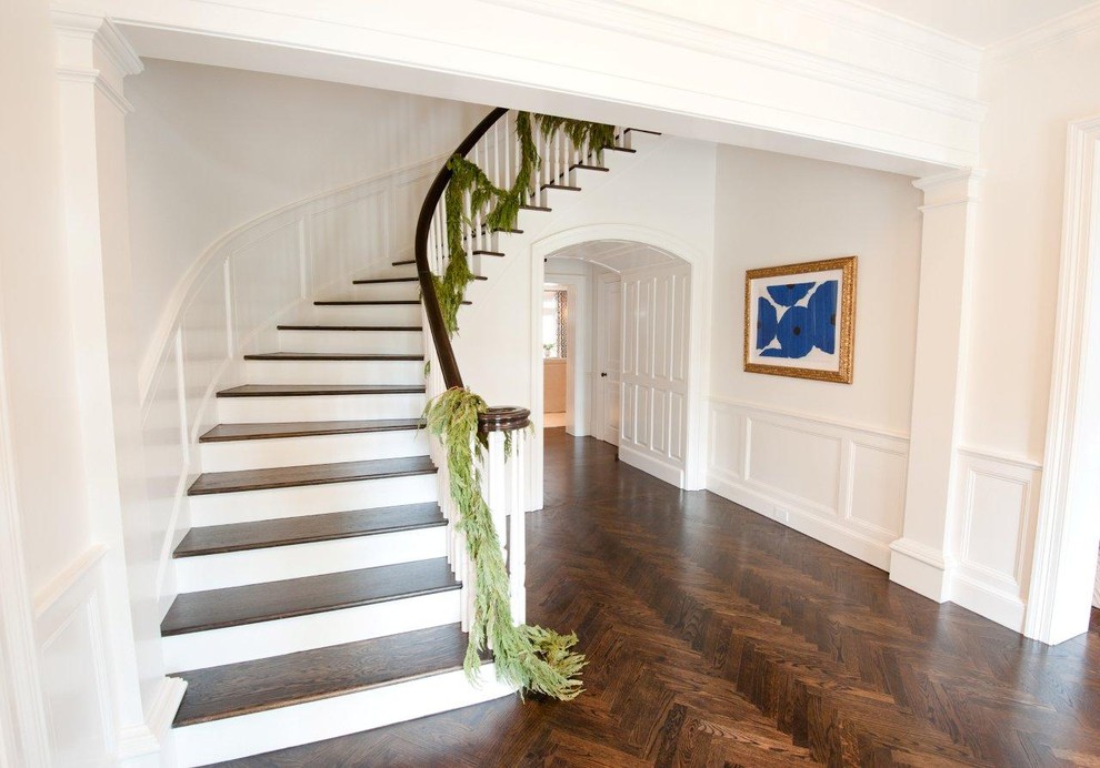 Example of a classic wooden curved staircase design in Houston