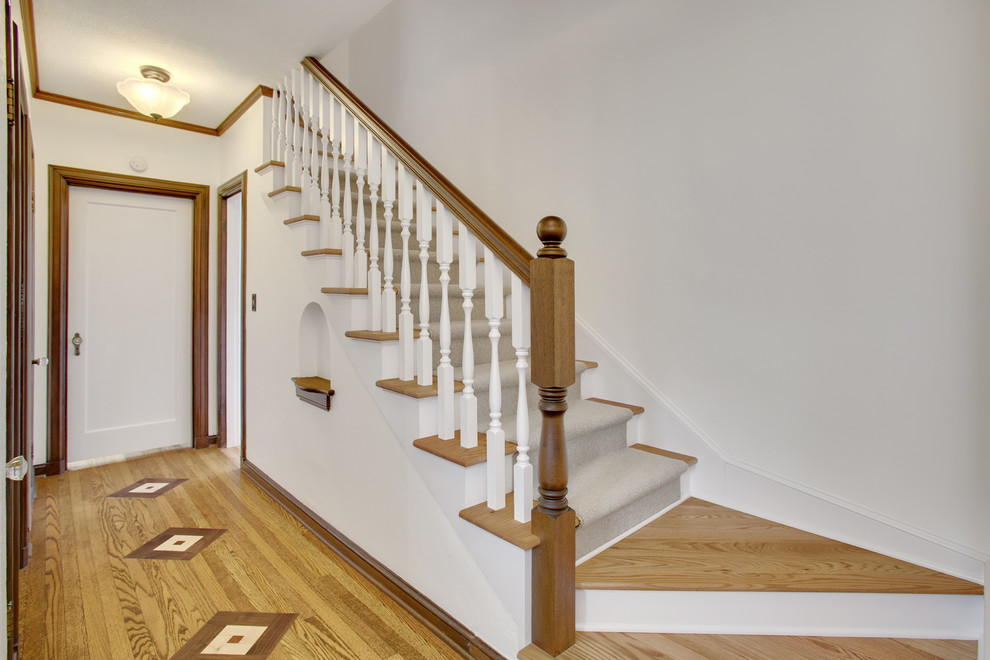 Design ideas for a small classic carpeted straight staircase in Seattle with wood risers and feature lighting.