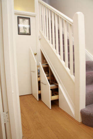 Traditional staircase in London with under stair storage.
