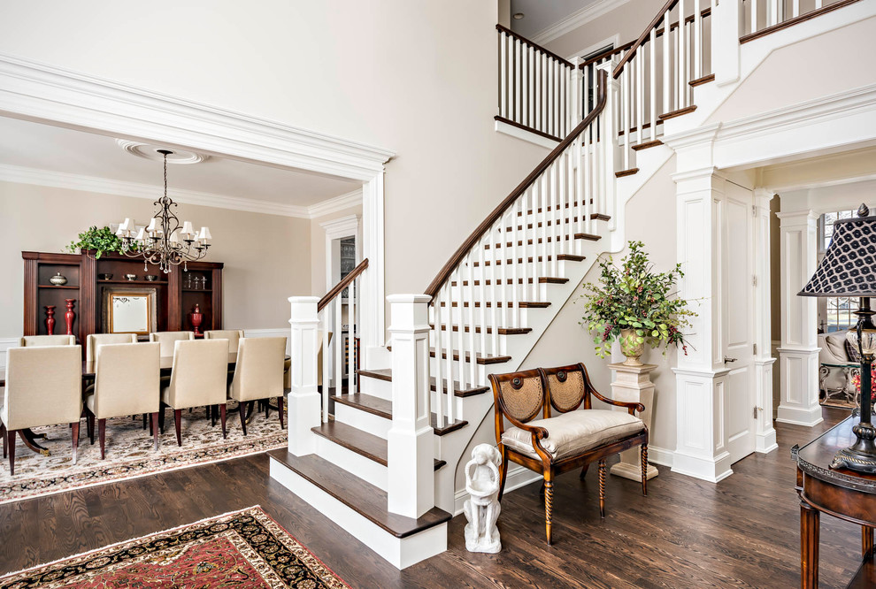 Photo of a classic wood l-shaped wood railing staircase in Chicago with painted wood risers.