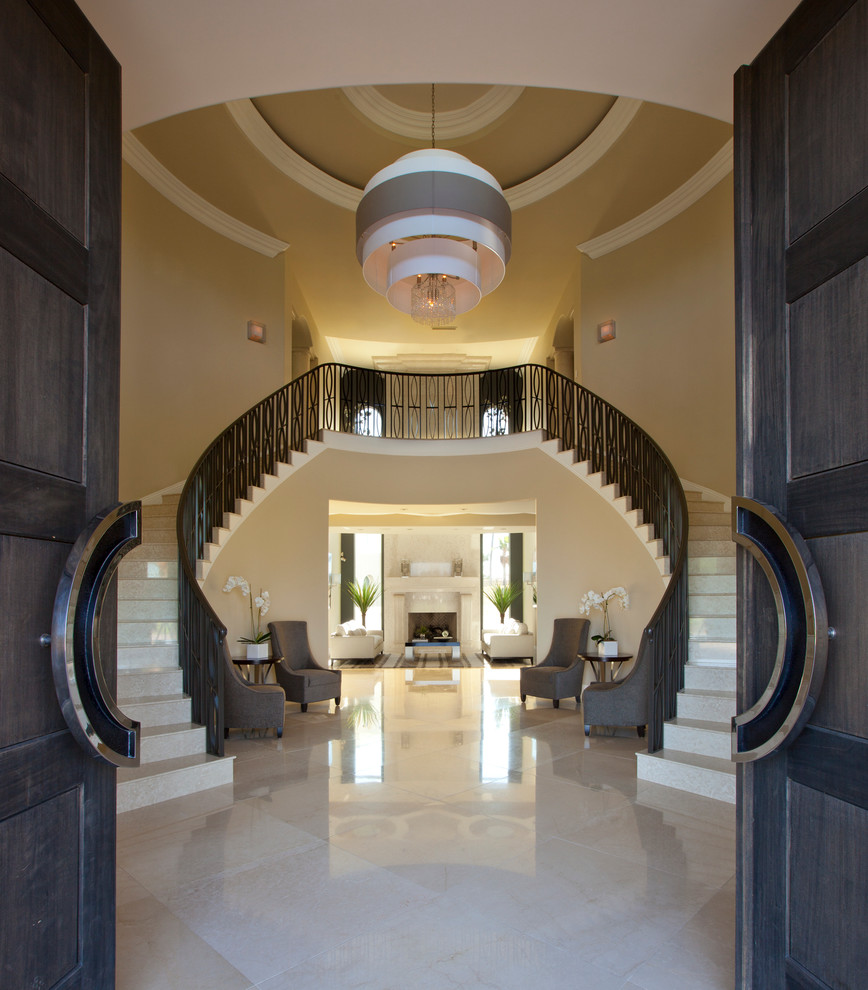Example of a huge trendy travertine curved metal railing staircase design in Phoenix with travertine risers