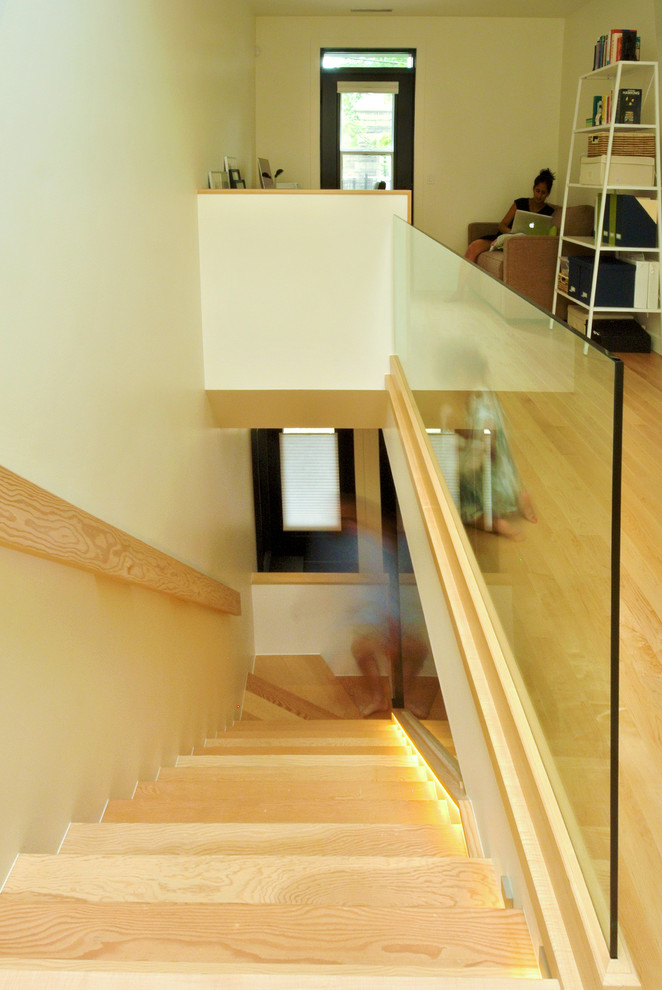 Inspiration for a medium sized contemporary wood l-shaped glass railing staircase in Montreal with wood risers.