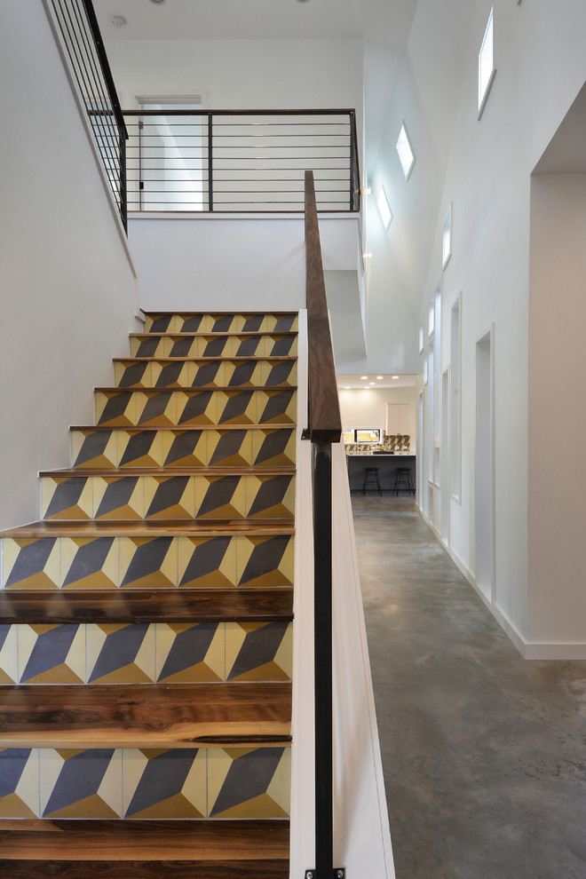 Inspiration for a mid-sized modern wooden u-shaped staircase remodel in Austin with tile risers