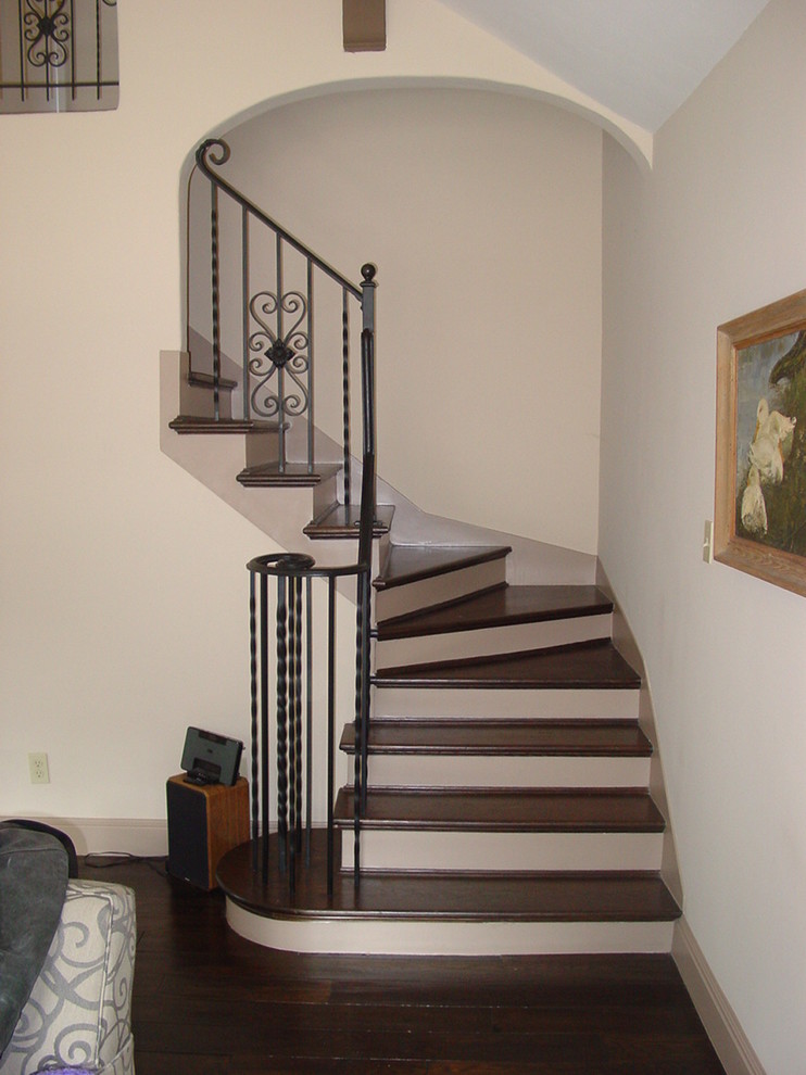 Idées déco pour un petit escalier courbe classique avec des marches en bois, des contremarches en bois et un garde-corps en métal.