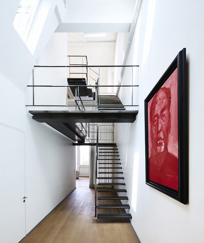 This is an example of a contemporary u-shaped staircase in New York with open risers.