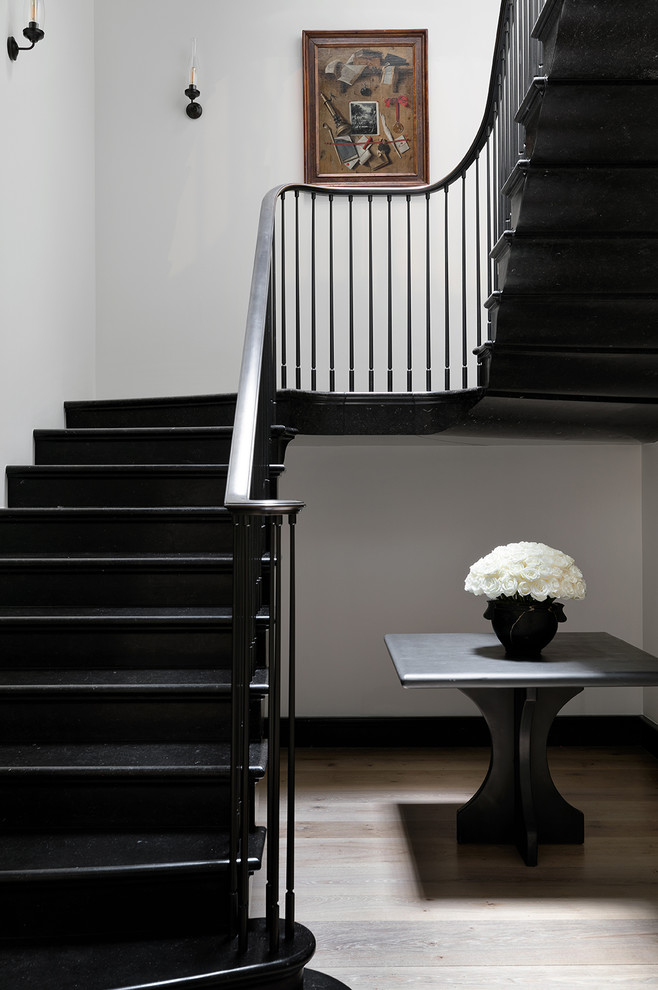 Minimalist curved metal railing staircase photo in New York