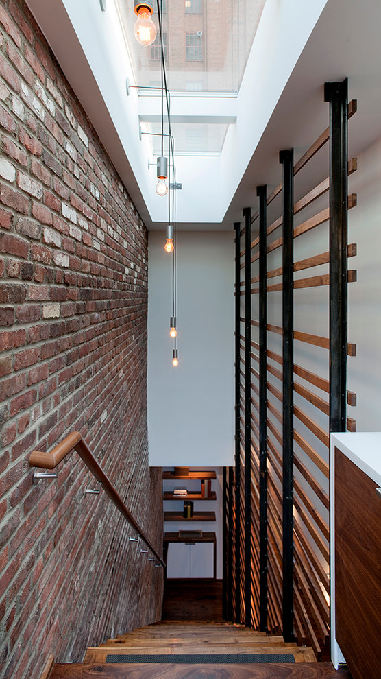 Large urban wood straight staircase in New York with open risers.