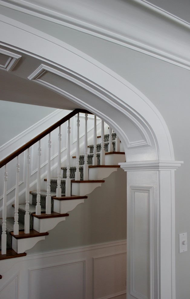 Inspiration for a medium sized classic staircase in Chicago with wainscoting.
