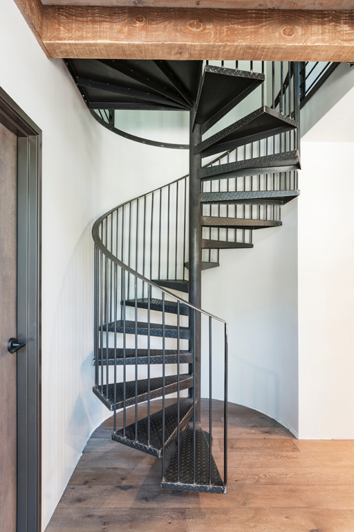 Example of a small urban metal spiral staircase design in Other with metal risers