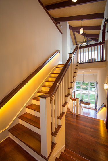 Example of a mid-sized island style wooden u-shaped staircase design in Hawaii with wooden risers