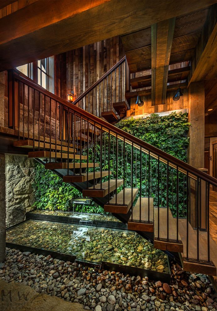 На фото: п-образная лестница среднего размера в стиле лофт с деревянными ступенями и металлическими перилами без подступенок с